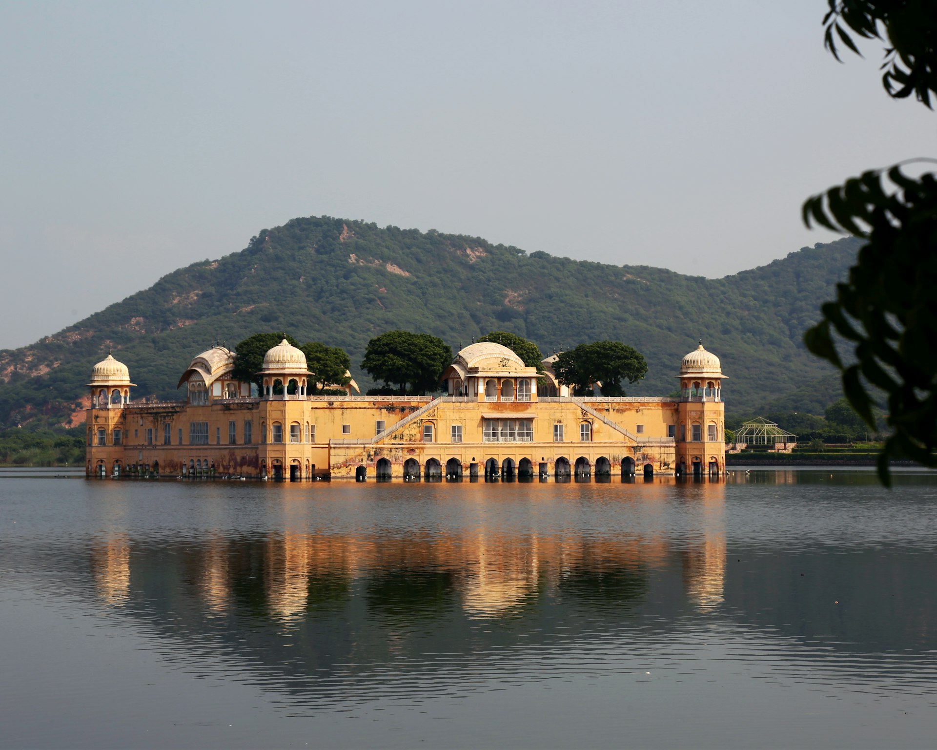 A large yellow building sitting on top of a lake